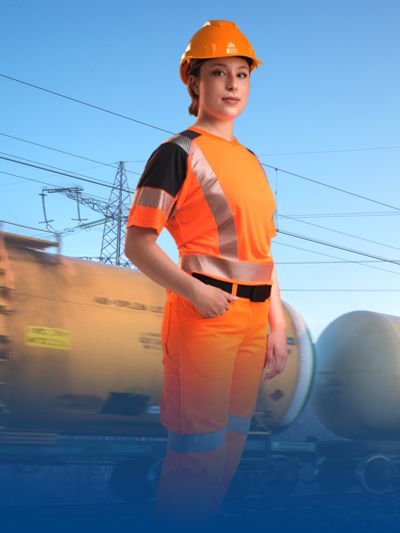 Woman wearing BProtected work clothing on railway tracks.