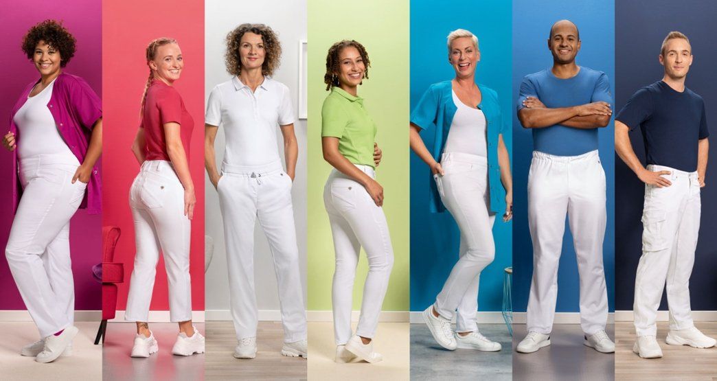 Seven nurses are dressed in various Med&Care work outfits.