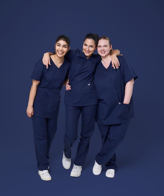 Three carers wear Med&Care outfits in midnight blue.
