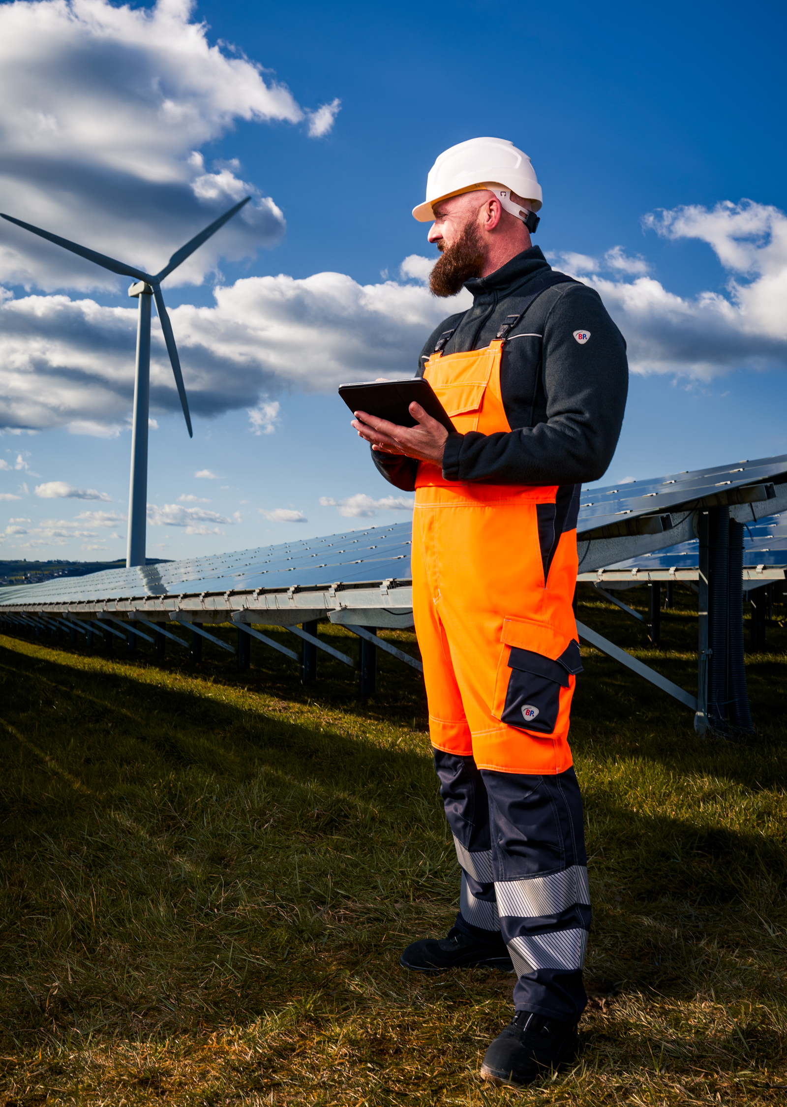 Man in work clothes standing on a solar installation.