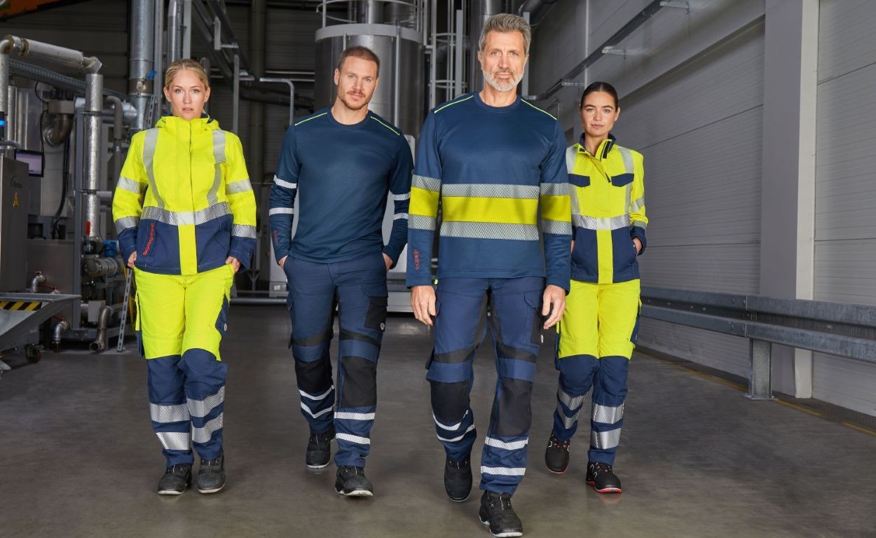 Team aus Frauen und Männern i9n Multinorm-Warnschutzkleidung.