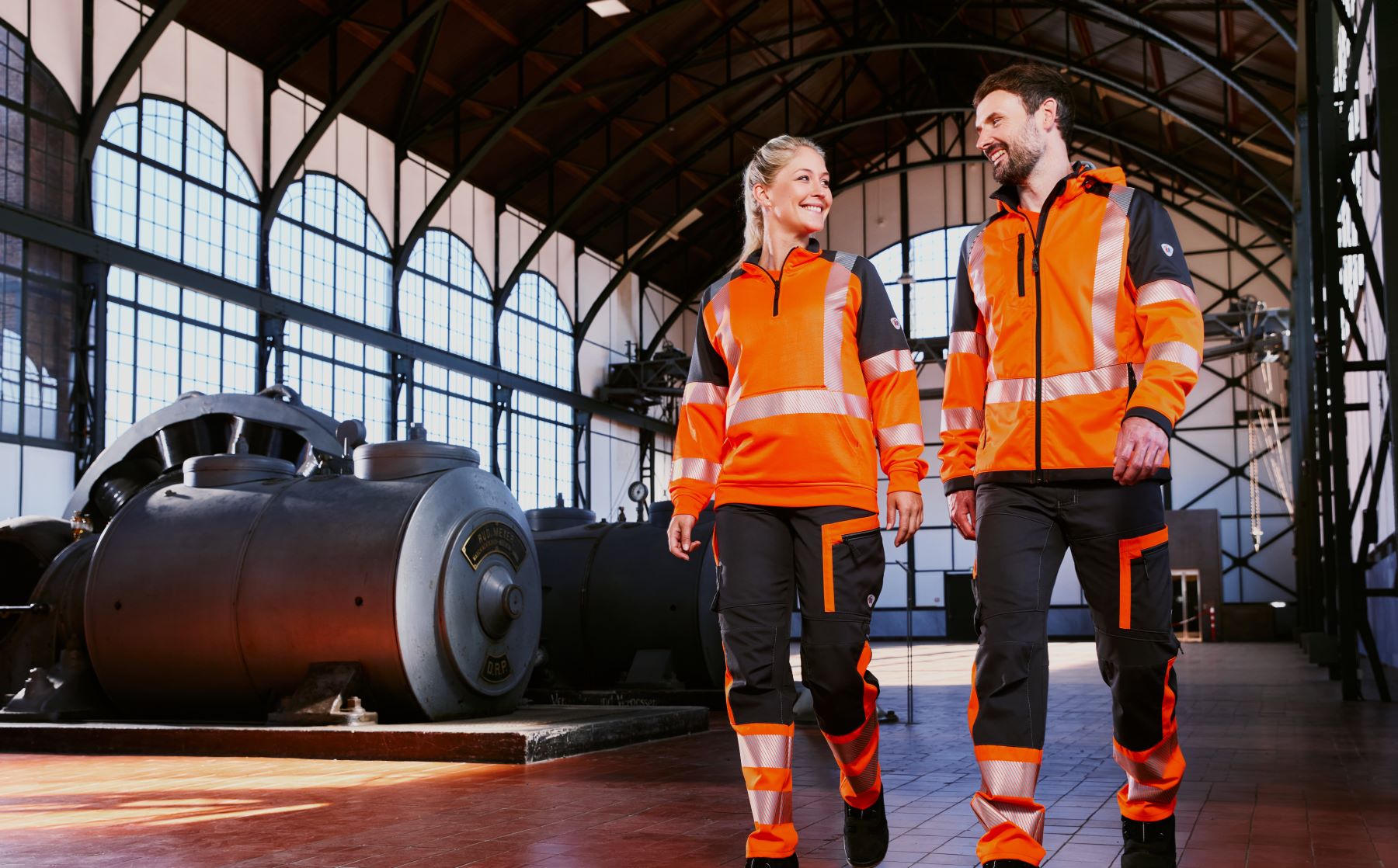 A woman and a man in high-visibility warning clothing.