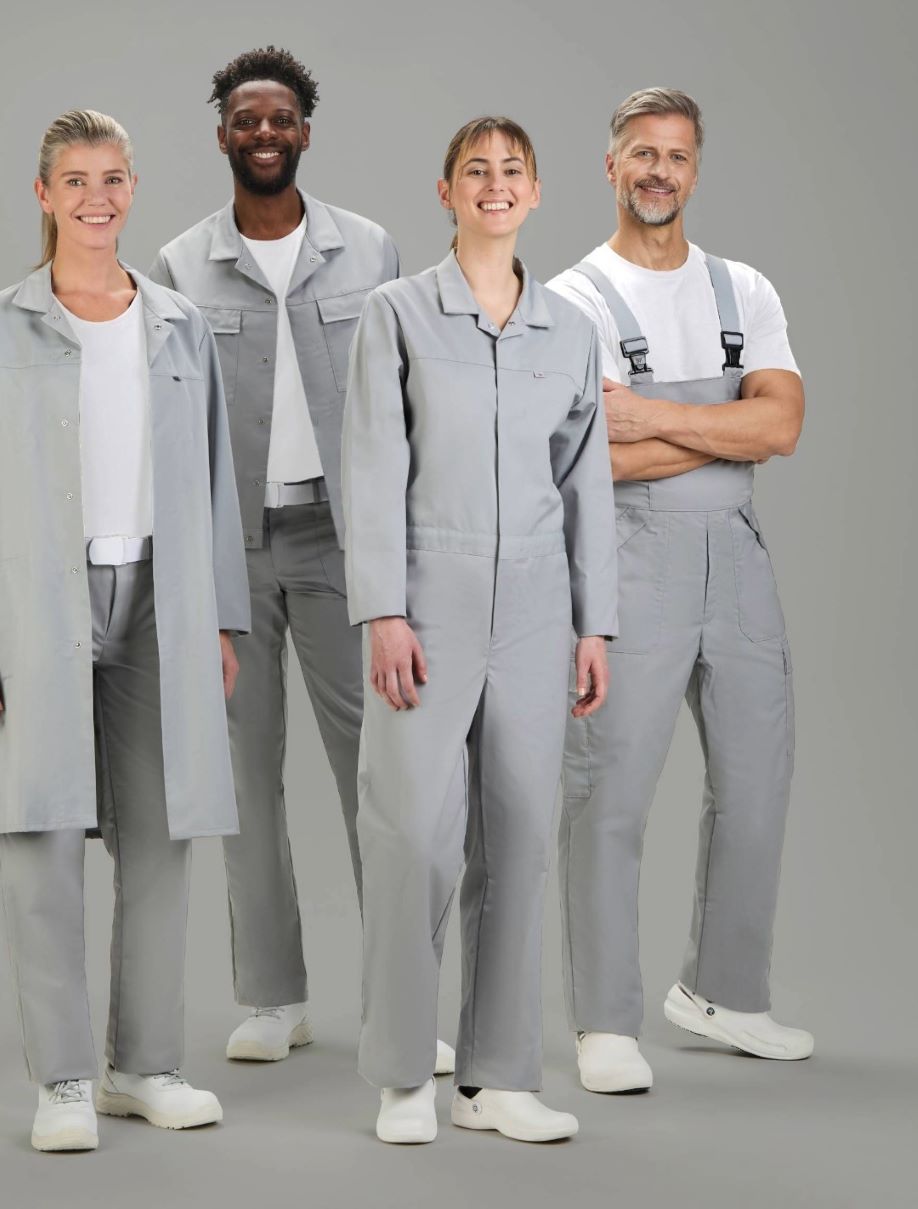 Zwei Frauen und zwei Männer tragen graue HACCP overalls.