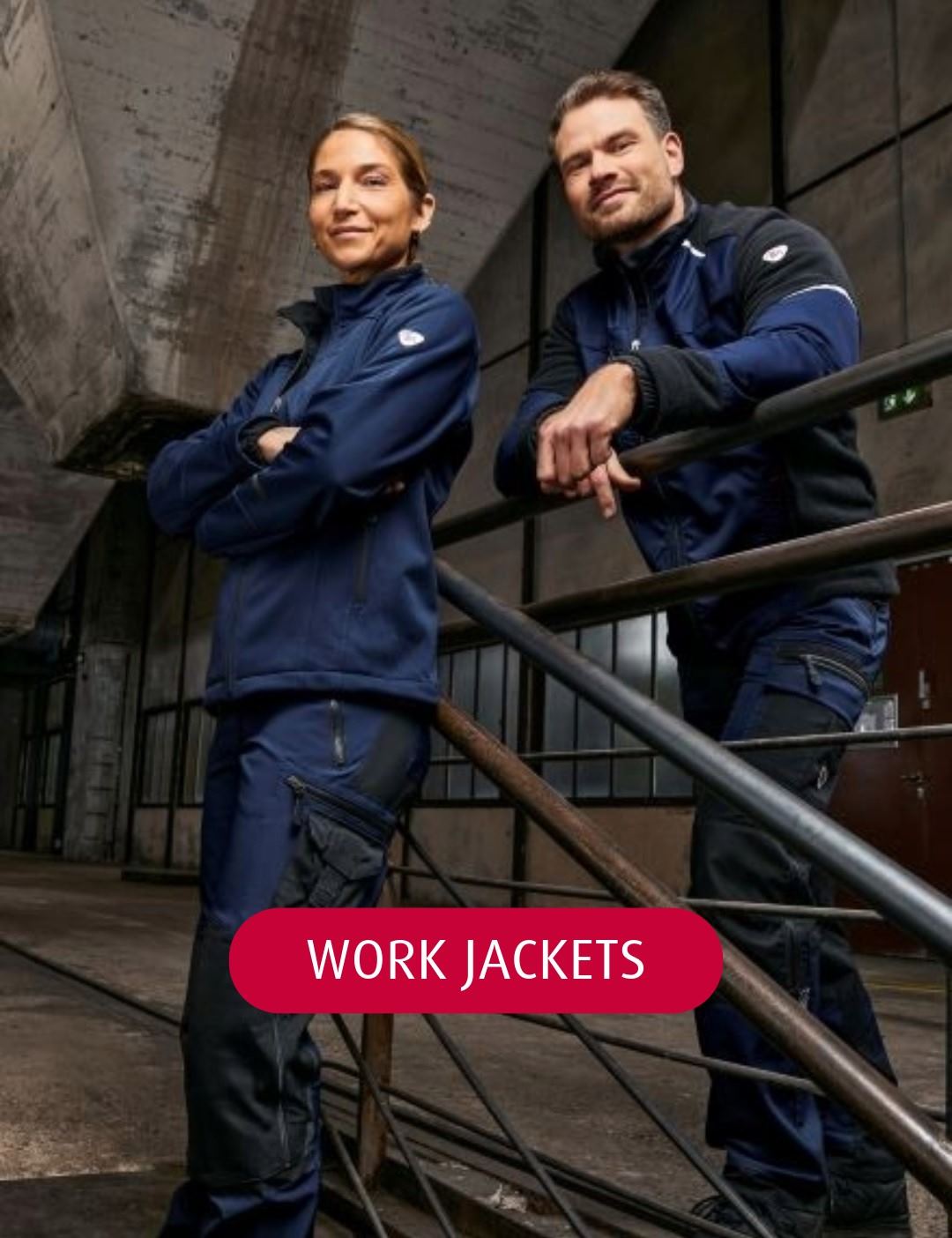 Man and woman wearing royal blue BP work trousers and a royal blue BP work jacket 