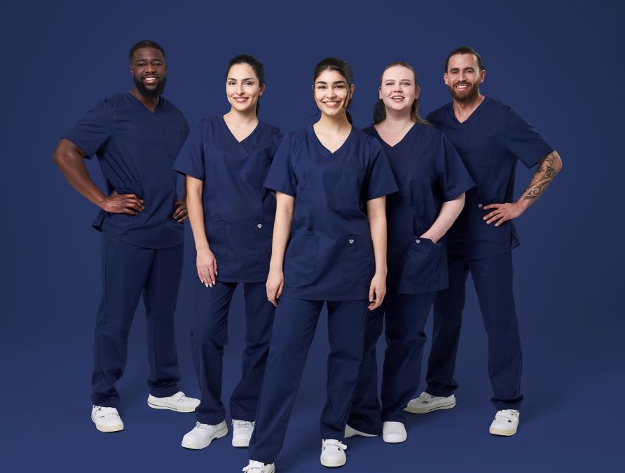 Three carers and two nurses wear Med&Care outfits in midnight blue.
