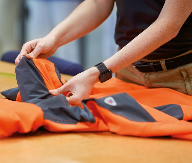 BP® employee checks the quality of a BP® jacket.